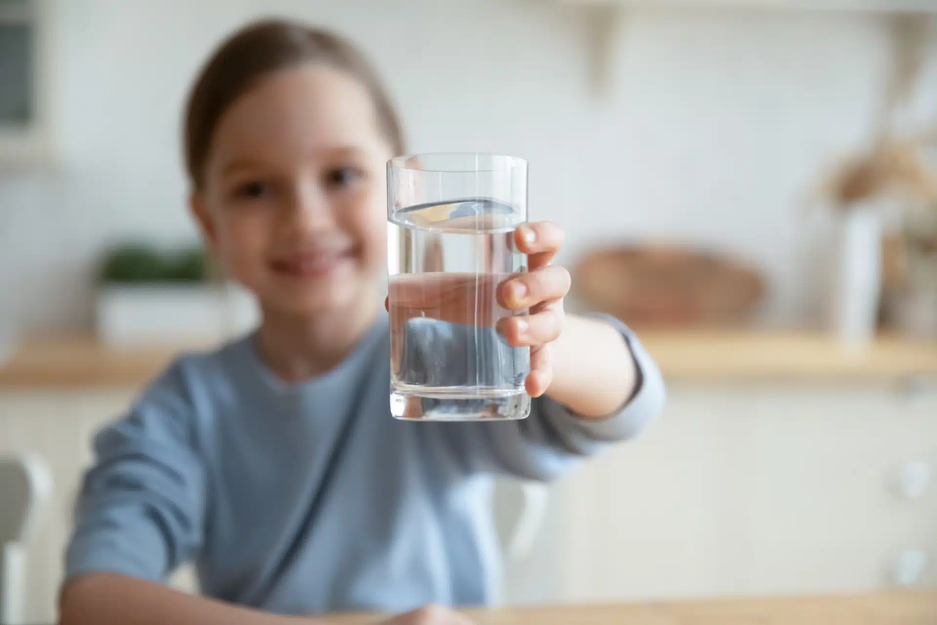 Girl offering a glass of water