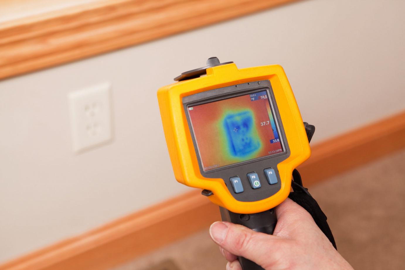 Infrared Thermal Imaging Camera Pointing to Wall Outlet