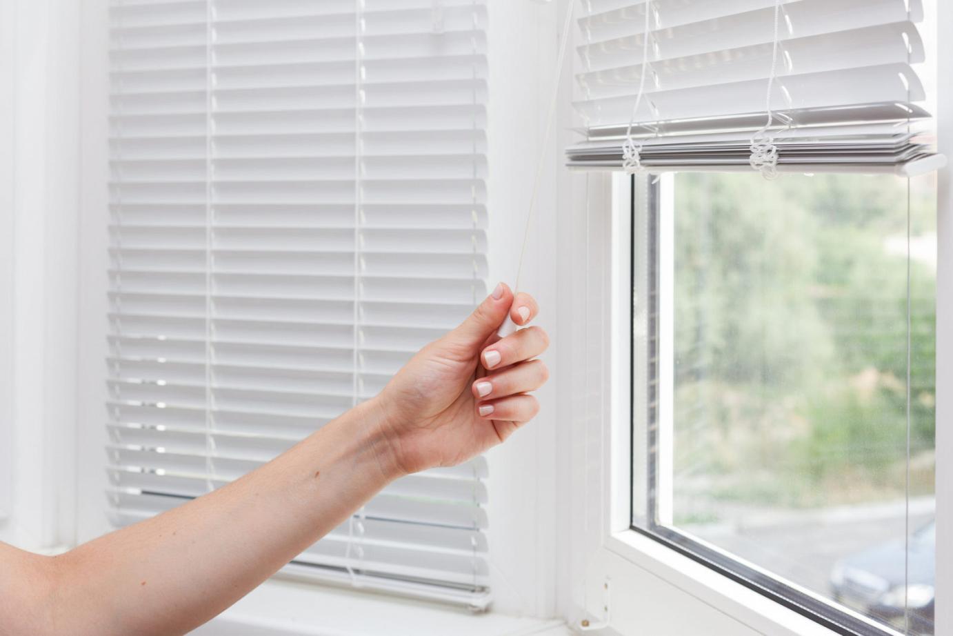 Hand adjusting the blinds